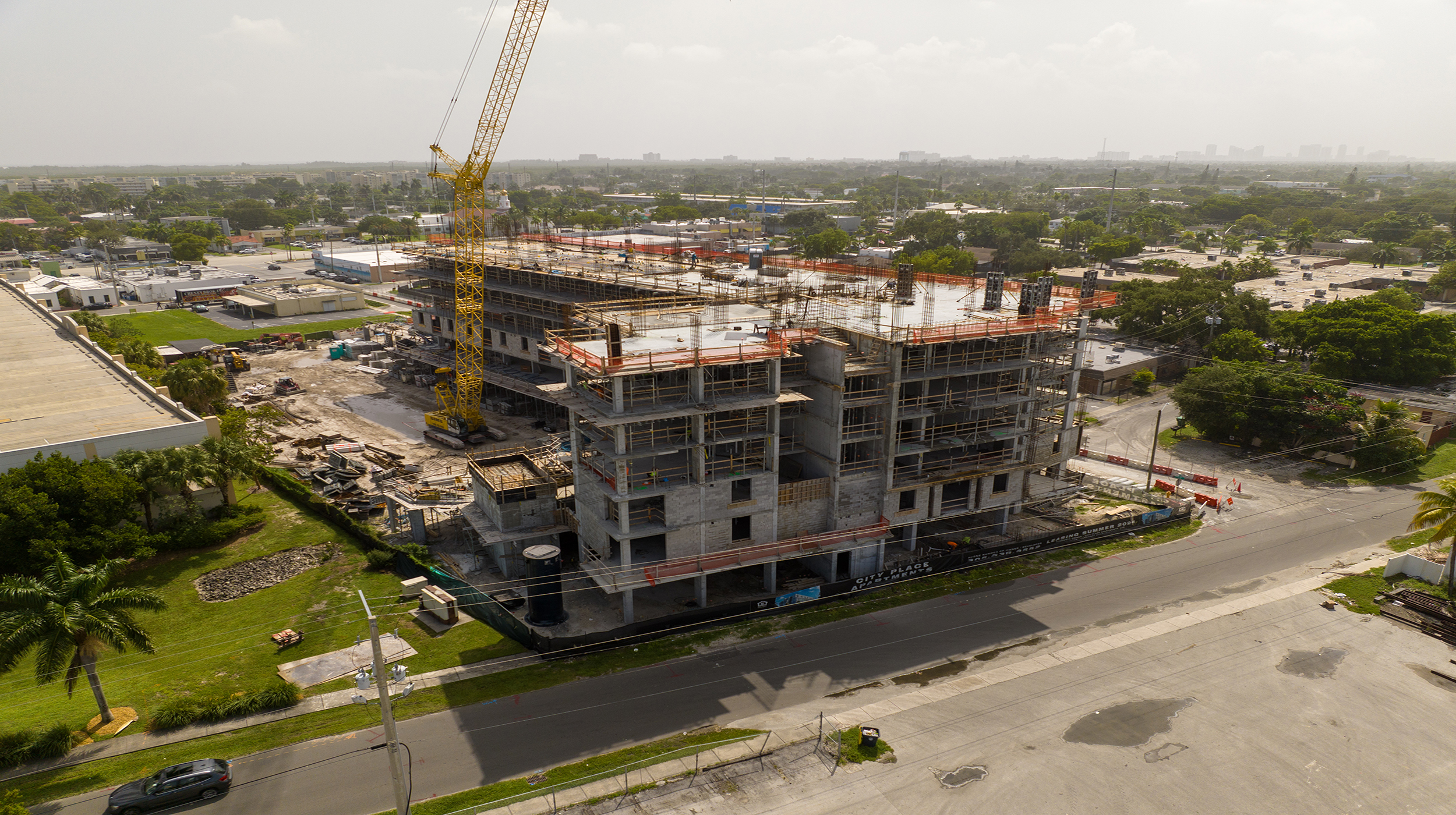 An 8-story residential building complex with 99 units and a two-level parking garage attached